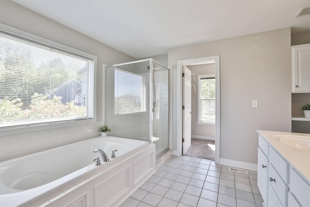 bathroom with tile patterned flooring, vanity, separate shower and tub, and plenty of natural light