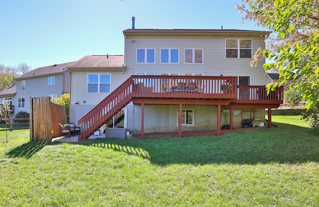 back of house with a lawn and a wooden deck