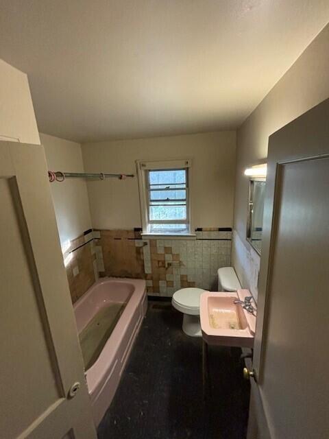 4370 Oliver Rd, Independence, KY 41051 - full bath featuring a sink, toilet, tile walls, and a wainscoted wall