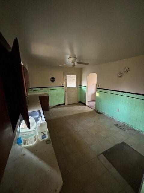 4370 Oliver Rd, Independence, KY 41051 - unfurnished living room featuring wainscoting, ceiling fan, and light floors