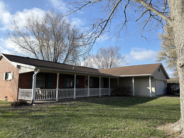 rear view of house with brick siding, a yard, and an attached garage