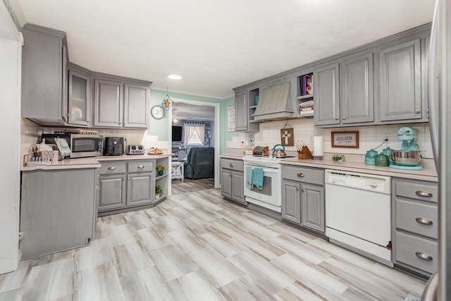 kitchen with open shelves, white appliances, custom range hood, light countertops, and pendant lighting