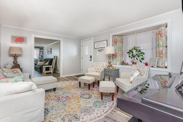 living room with ornamental molding, baseboards, and wood finished floors