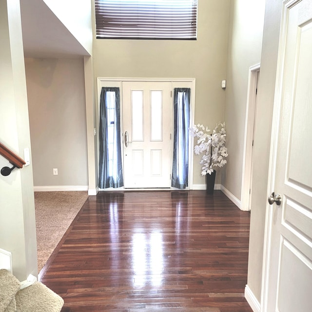 entryway featuring stairway, baseboards, and wood finished floors