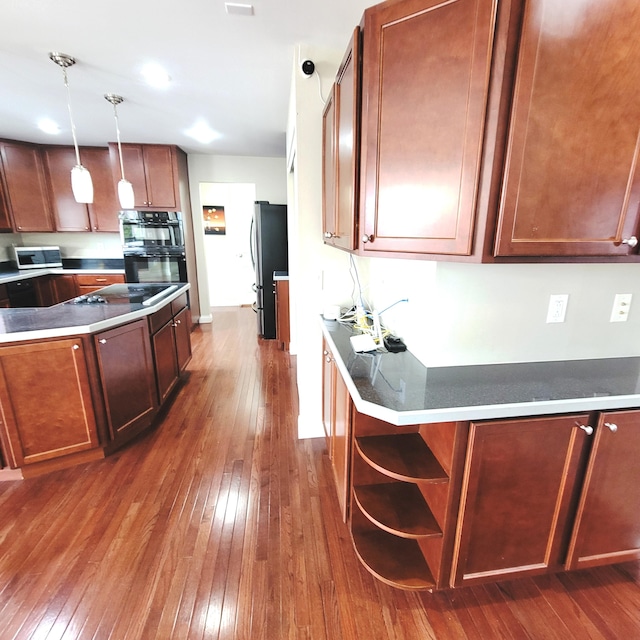 kitchen with hanging light fixtures, black appliances, dark wood-style floors, and open shelves