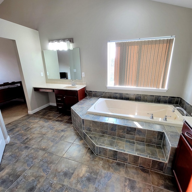 full bath featuring a garden tub and vanity