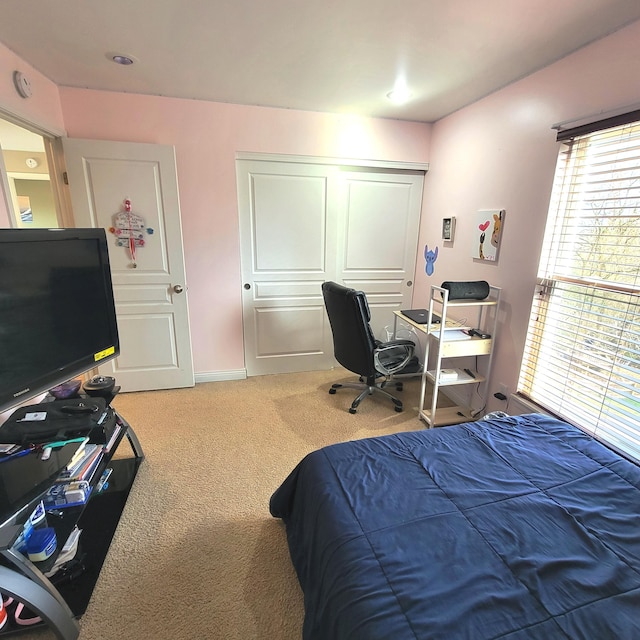 carpeted bedroom featuring a closet