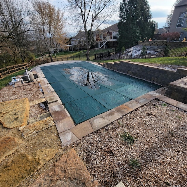 view of swimming pool featuring fence and a fenced in pool