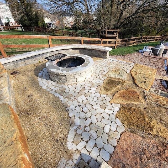 exterior space featuring a fire pit and fence