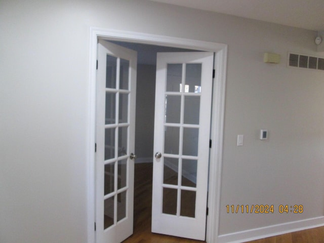 interior space featuring french doors and hardwood / wood-style flooring