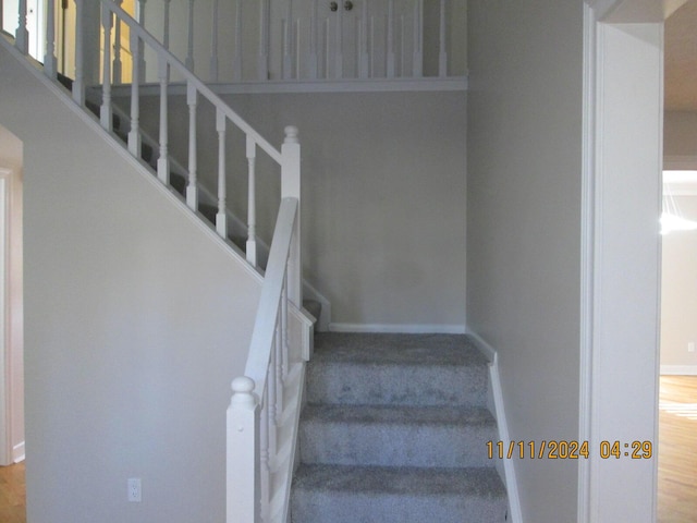 staircase with hardwood / wood-style flooring