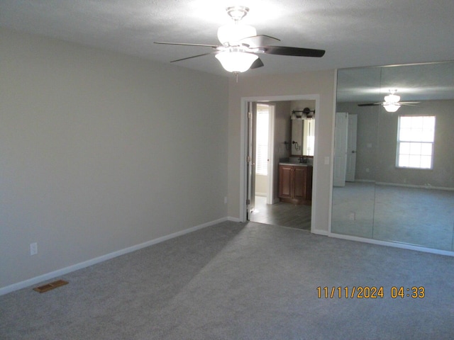 unfurnished bedroom featuring carpet flooring and ceiling fan