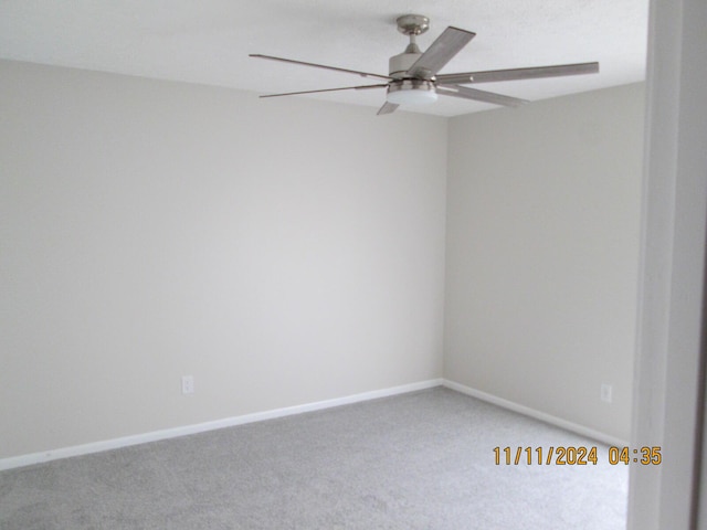 spare room featuring carpet and ceiling fan