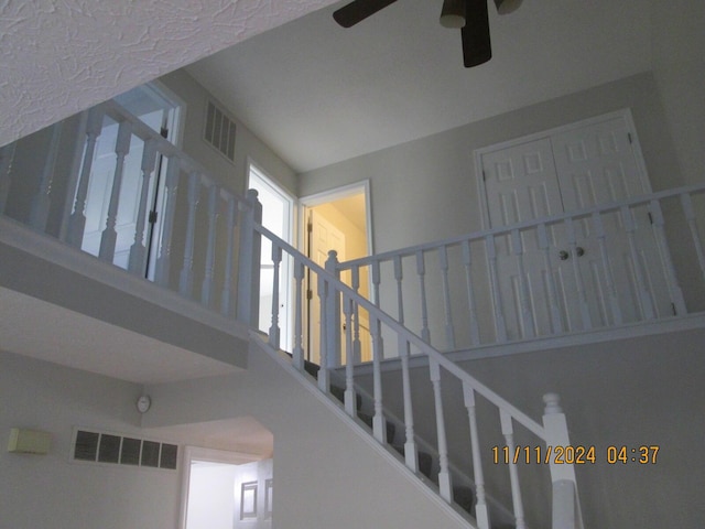 staircase with ceiling fan