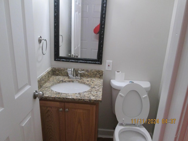 bathroom featuring vanity and toilet