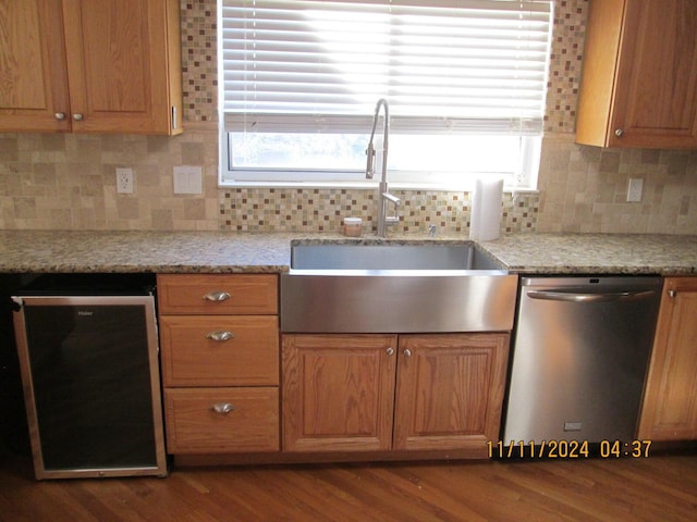 kitchen with dishwasher, hardwood / wood-style flooring, a healthy amount of sunlight, and sink