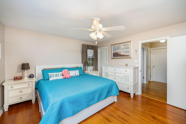 bedroom with ceiling fan and dark hardwood / wood-style flooring