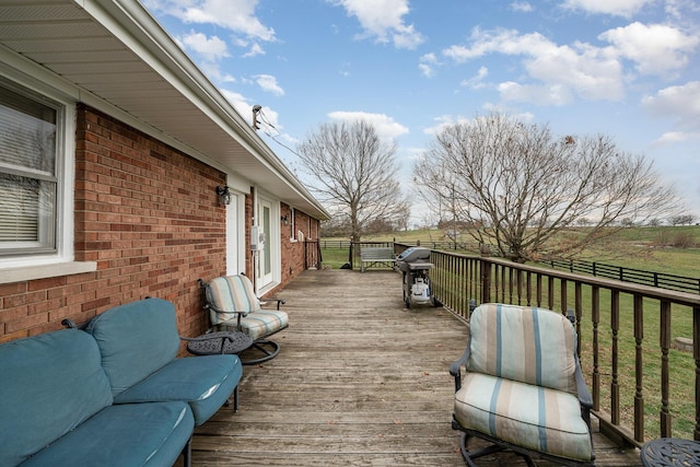 wooden terrace featuring a lawn and a grill