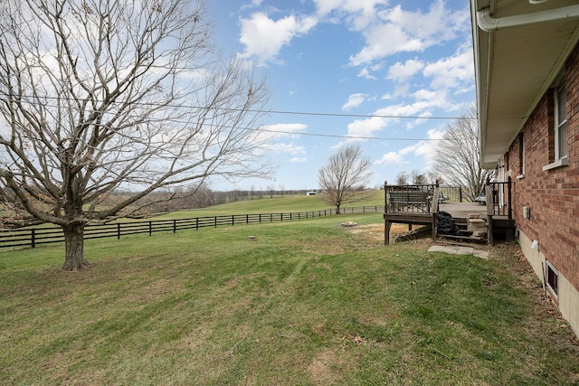 view of yard with a rural view and a deck