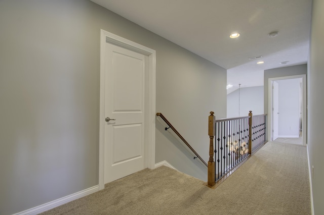 staircase featuring carpet and vaulted ceiling