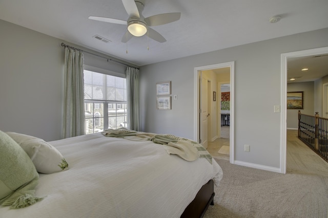 bedroom featuring ceiling fan and light carpet