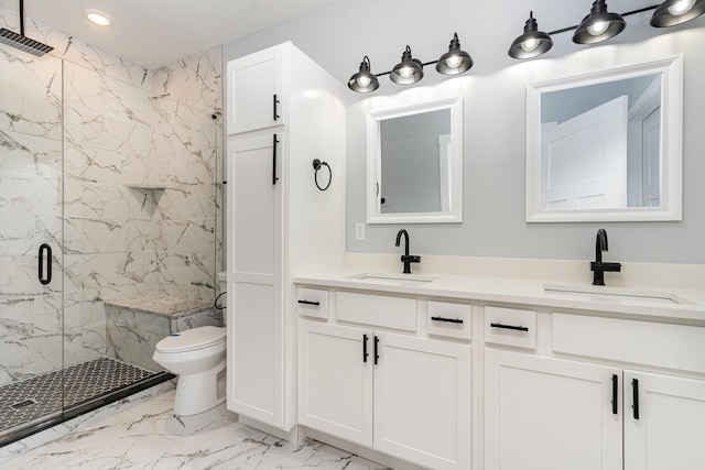 bathroom featuring a shower with door, vanity, and toilet