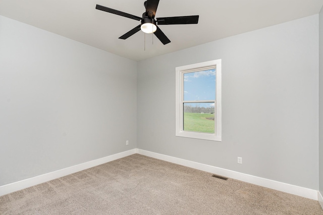 carpeted spare room featuring ceiling fan