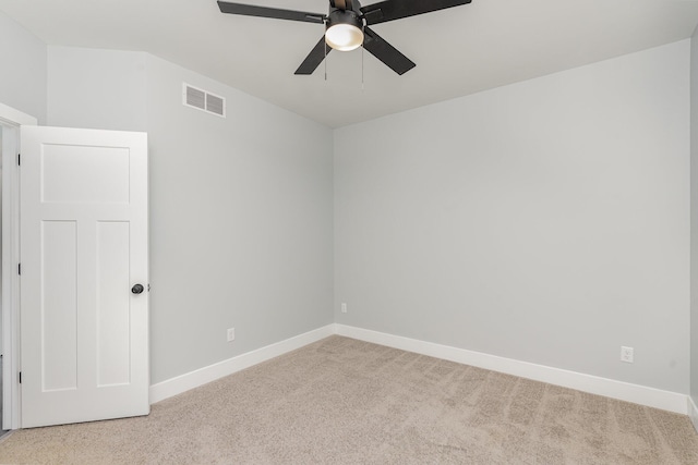 empty room featuring ceiling fan and light colored carpet