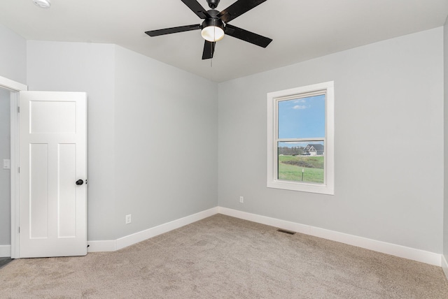 spare room with light colored carpet and ceiling fan