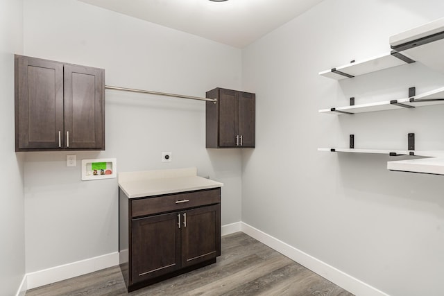 laundry area with electric dryer hookup, cabinets, dark wood-type flooring, and washer hookup