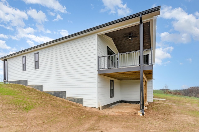 view of side of property with ceiling fan