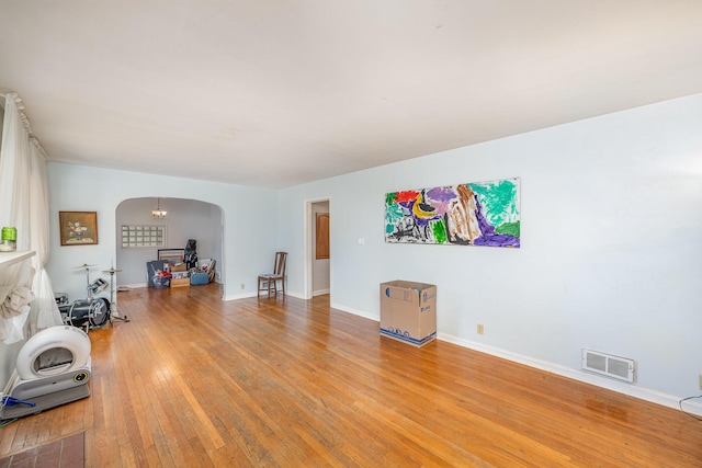 interior space with hardwood / wood-style floors and an inviting chandelier