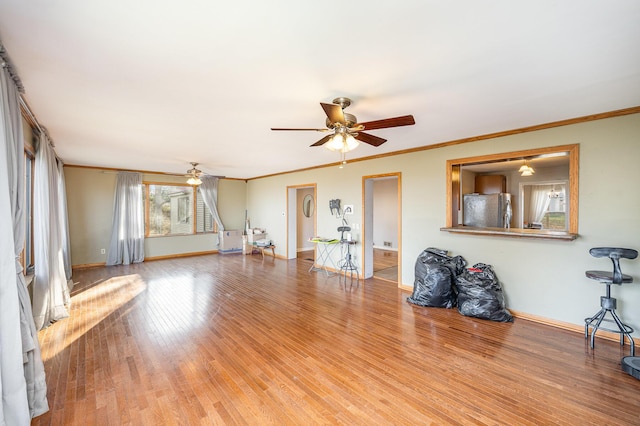 unfurnished living room featuring hardwood / wood-style floors, ceiling fan, and ornamental molding