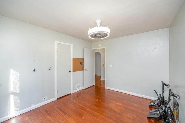 empty room with hardwood / wood-style flooring