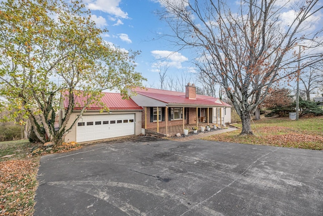 ranch-style house featuring a porch and a garage