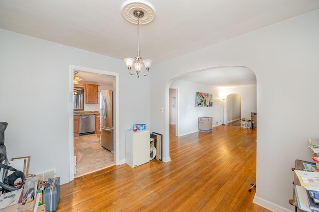 dining area with a chandelier and light hardwood / wood-style floors