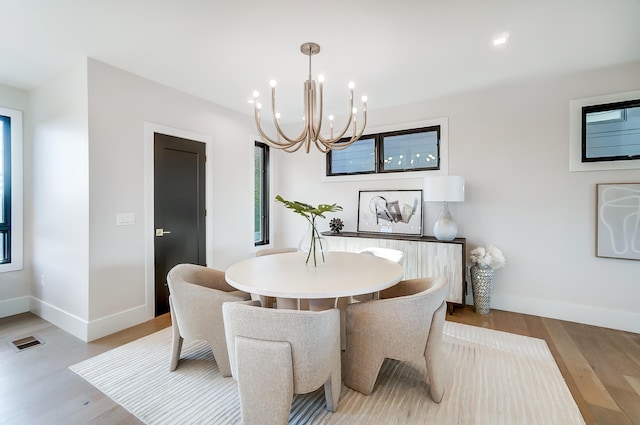 dining room with an inviting chandelier and light wood-type flooring