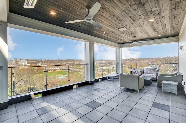 unfurnished sunroom with ceiling fan and wood ceiling