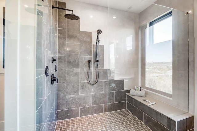 bathroom with a tile shower