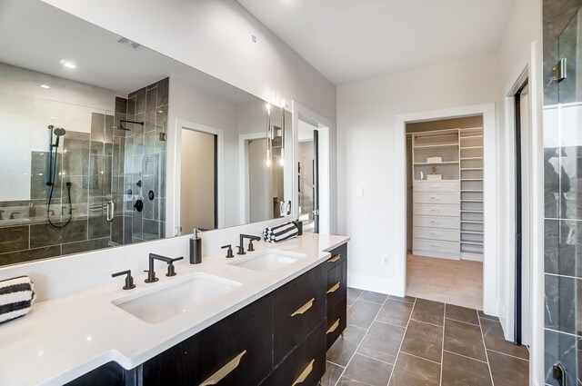 bathroom featuring tile patterned flooring, vanity, and walk in shower