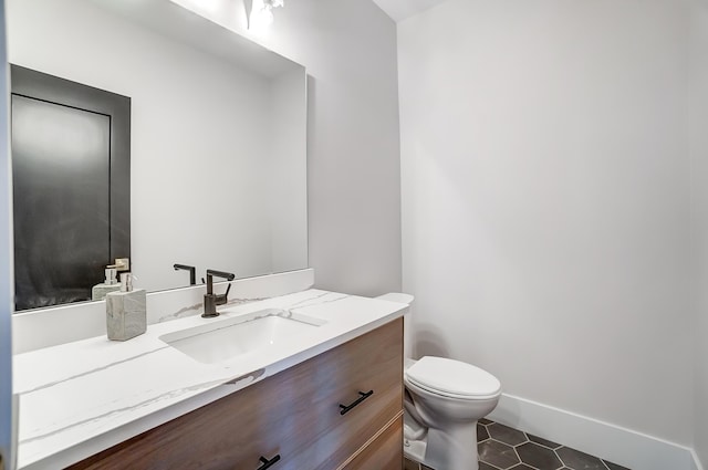 bathroom featuring tile patterned flooring, vanity, and toilet