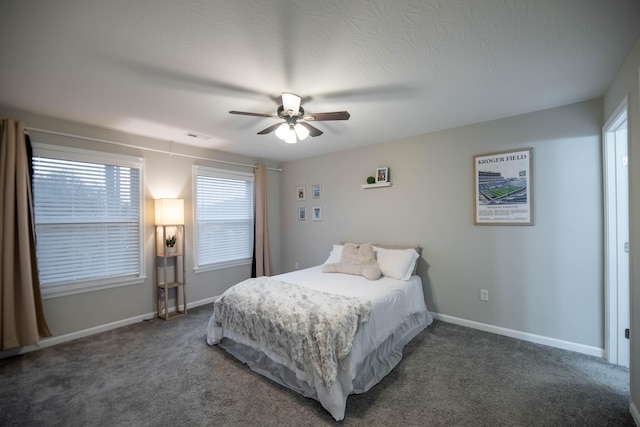 bedroom with ceiling fan and dark carpet