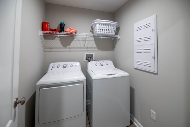 clothes washing area featuring separate washer and dryer