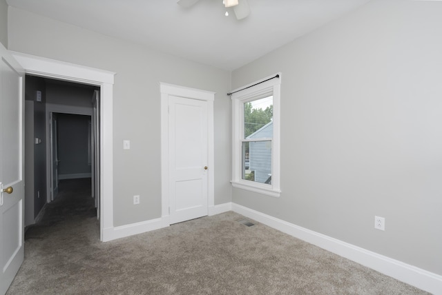 unfurnished bedroom featuring carpet and ceiling fan