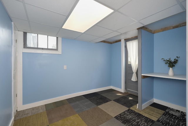 basement with a paneled ceiling