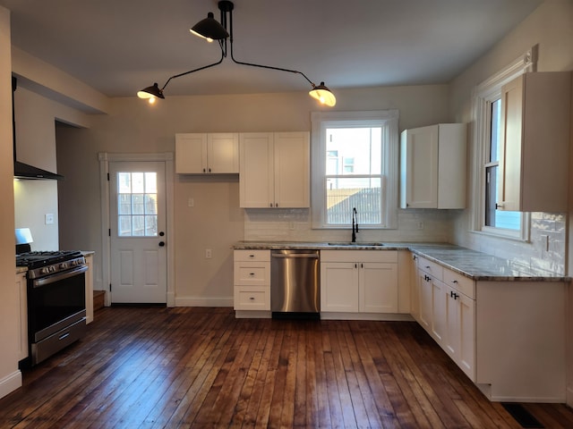 kitchen with a wealth of natural light, white cabinetry, and appliances with stainless steel finishes