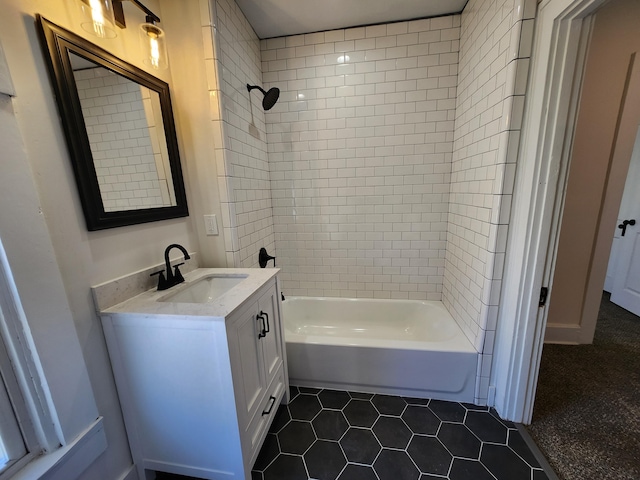 bathroom with tile patterned floors, vanity, and tiled shower / bath combo