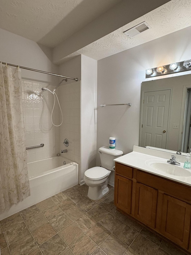 full bathroom with vanity, a textured ceiling, toilet, and shower / bath combo with shower curtain