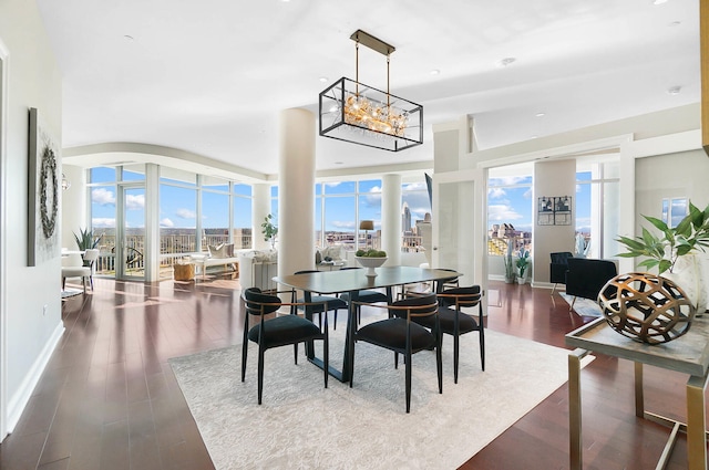 dining space featuring a chandelier, hardwood / wood-style flooring, and expansive windows