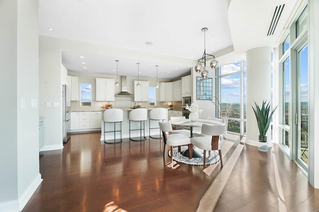 dining space with a notable chandelier and dark hardwood / wood-style floors